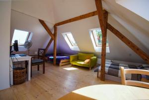 a attic room with a bed and a couch at Apartmán Národní in Karlovy Vary