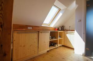 a kitchen with wooden cabinets and a window at Apartmán Národní in Karlovy Vary