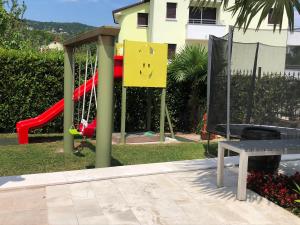 a playground with a slide and a bench at Apartments Villa Učka in Opatija