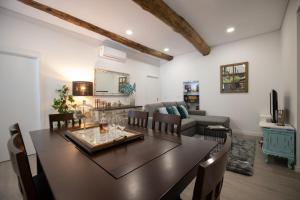 a dining room and living room with a table and chairs at Casa dos Avós- Douro in Peso da Régua