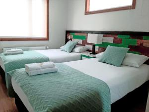 Postel nebo postele na pokoji v ubytování Hostal Buenavista Patagonia