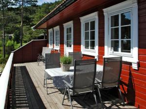 a deck with chairs and a table on a house at Chalet Kosekroken - SOW081 by Interhome in Fossdal