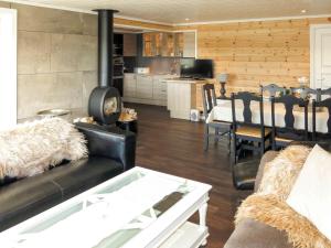 a living room with a couch and a dining room at Chalet Doghouse - SOW048 by Interhome in Øyuvstad