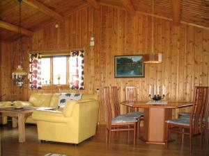 a living room with a couch and a table at Chalet Vemhån Byn - HJD062 by Interhome in Vemhån