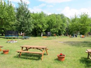 a park with picnic tables and a playground at Holiday Home Ferienpark Verchen-3 by Interhome in Verchen