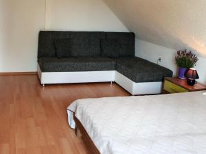 a bedroom with a bed and a couch at Holiday Home Ferienpark Verchen-3 by Interhome in Verchen +9 photos