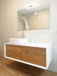 a bathroom with a sink and a mirror at Guest House - La bella vita in Orosei