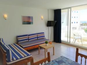 a living room with a couch and a table at Trill Mirasol C primera linea mar L'Estartit in L'Estartit