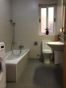 a bathroom with a tub and a toilet and a sink at Ocean Pearl Apartment no4 in St Paul's Bay +28 photos