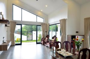a living room with a table and chairs at Villa Kim Yến Lagi in La Gi +30 photos