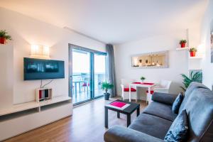a living room with a couch and a tv at Sa Maniga 3i in Cala Millor