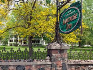 a sign for a marvellous inn behind a fence at Montrose Inn in Belleville