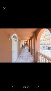 a hallway of a building with an archway and a hallway sidx sidx at Miami Beach 39 in Benalmádena