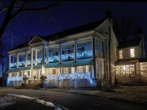 a building with christmas lights on it at night at Montrose Inn in Belleville