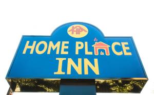 a sign for a home plate inn at Home Place Inn in Houston