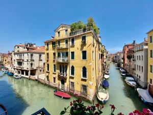 a view of a canal with boats and buildings at Suite House new apartments canal view Venice island in Venice