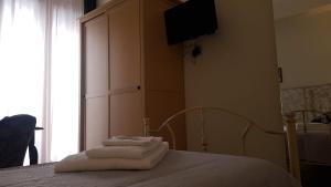 a bedroom with a bed with towels on it at Santa Caterina da Siena B&B in Catania