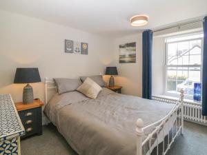 een slaapkamer met een bed en een raam bij Rosebank Cottage in Woolacombe