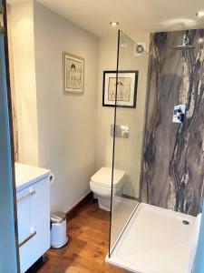 a bathroom with a shower and a toilet at The Inn at Cheltenham Parade in Harrogate