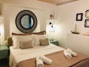 a bedroom with a large bed with towels on it at Klaras House in Platis Yialos Mykonos