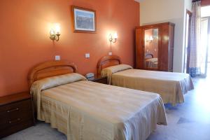 Postel nebo postele na pokoji v ubytování Hotel Central