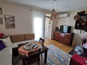 a living room with a couch and a table at Apartman Selma in Vinine