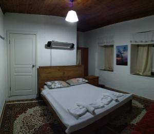 a bedroom with a bed with towels on it at KARABURUN KÖYEVİ Pansiyon in Saip +18 photos