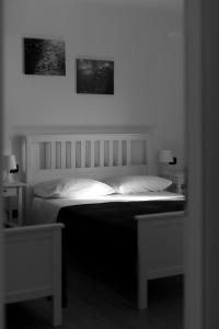 a bedroom with a bed with two pictures on the wall at L'oasi di Giorgia in Cittadella del Capo