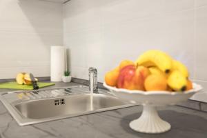 a bowl of fruit sitting next to a sink at Apartments Santa Maria in Dubrovnik +63 photos