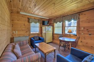 a living room with a couch and a table at Quiet Waterfront Cabin with Dock, Game Room, Hot Tub in Greenwood