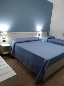 A bed or beds in a room at B&B Villa Marinetti