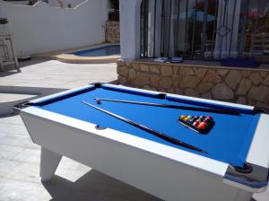 a pool table sitting in front of a building at Villa Rod,8p,airco,pool in Calpe