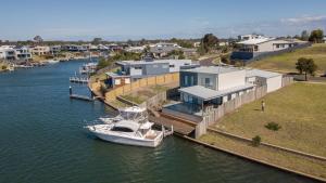 a boat is docked at a dock in the water at Anchored in Paynesville