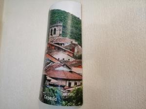 a bottle with a picture of a building at Casa Rural Amelia in Cepeda