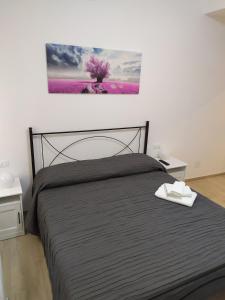 ein Schlafzimmer mit einem Bett und einem Wandgemälde in der Unterkunft Siclanda Home in Sanremo