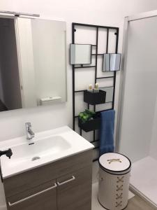 a bathroom with a sink and a mirror at Alojamiento La Colonia in Águilas +35 photos