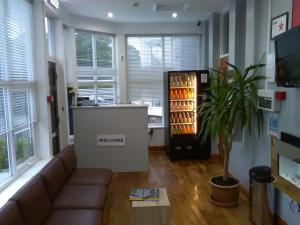 a living room with a couch and a drink cooler at Clifton Hotel & Bar Newcastle in Elswick