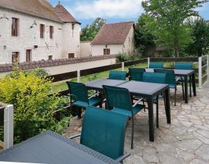 a group of tables and chairs on a patio at Hôtel Le Dormeux in Mehun-sur-Yèvre