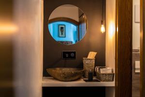 a bathroom with a bowl sink and a mirror at Pension Rudolph in Gaschurn