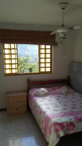 Uma cama ou camas num quarto em Sitio Sao Jeronimo