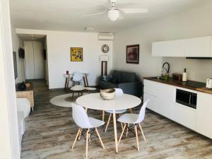 a kitchen and a living room with a table and chairs at La Bo-Aime in Orient Bay