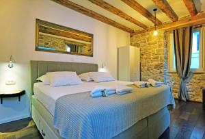 a bedroom with a large bed with blue pillows at Pearl Stone Apartments in Šibenik