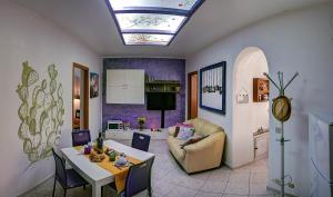 een keuken en een woonkamer met een tafel en een bank bij My House Holiday Apartment in Palermo