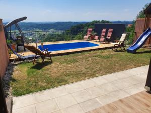 a backyard with a slide and a swimming pool at Hygge Hill in Krapinske Toplice