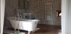a bathroom with a white tub in a room at La Maison Josnes de Mady in Josnes +28 photos