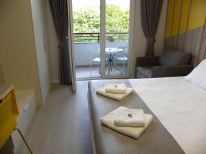 a hotel room with a bed with towels on it at Apartments Kanevce City Center in Ohrid +51 photos