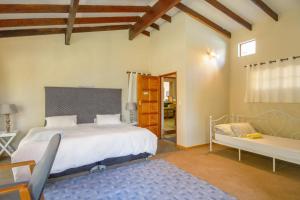 a bedroom with a bed and a bench in it at Thabametsi Farm in Maanhaarrand +133 photos