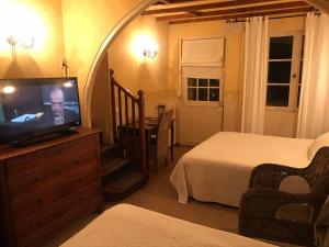 a bedroom with a bed and a television in a room at La Marjolaine in Juan-les-Pins