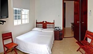 Voodi või voodid majutusasutuse Hotel Savoy toas