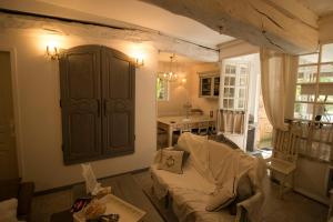 a living room with a couch and a cabinet at Gîte "Le Bleu D'Orage" Dans un Domaine de 7ha Au Calme in Vimoutiers